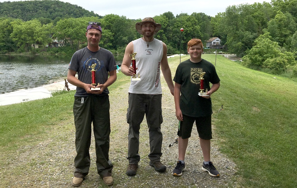 3 fishermen holding trophies